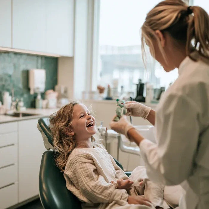 Little girl laughing in the dental chair